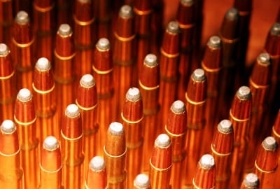 A close up of a group of 22 Rimfire bullets.