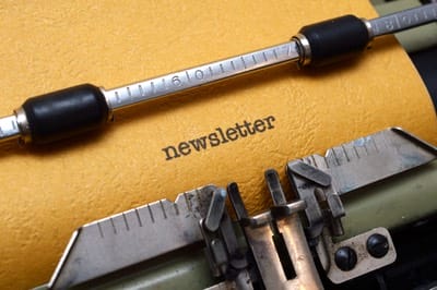 An old typewriter with the word newsletter written on it, ready for the February edition.