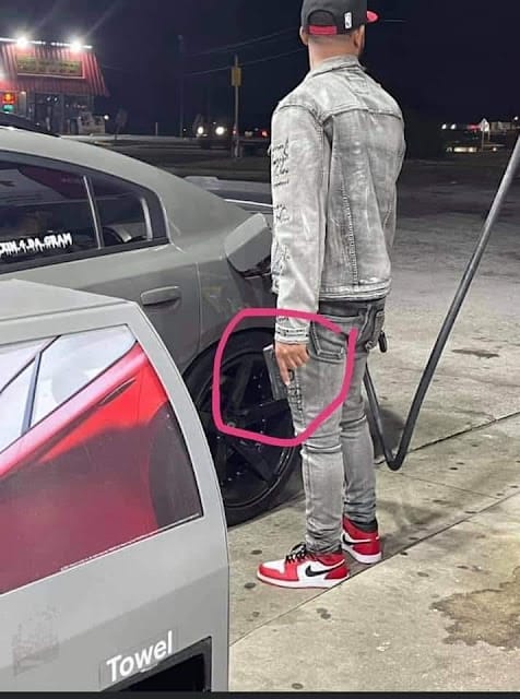 pumping gas with gun in hand