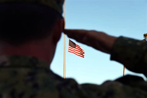 A soldier salutes the flag of the united states.