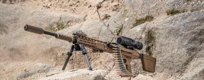 A military rifle sitting on top of a rock.