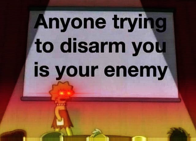 Image of a cartoon character with spiky red hair standing in front of a projection screen displaying the message "anyone trying to disarm you is your enemy.
