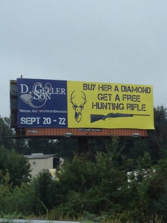 Billboard advertisement for "D. Geller & Son" promoting hunting rifles with diamond purchases, set against a cloudy sky and trees, dated September 20-22.