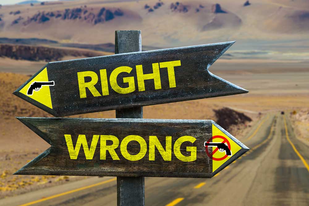 Two wooden signposts in a desert: one pointing right with "Right" and a gun image, the other pointing left with "Wrong" and a crossed-out gun image.