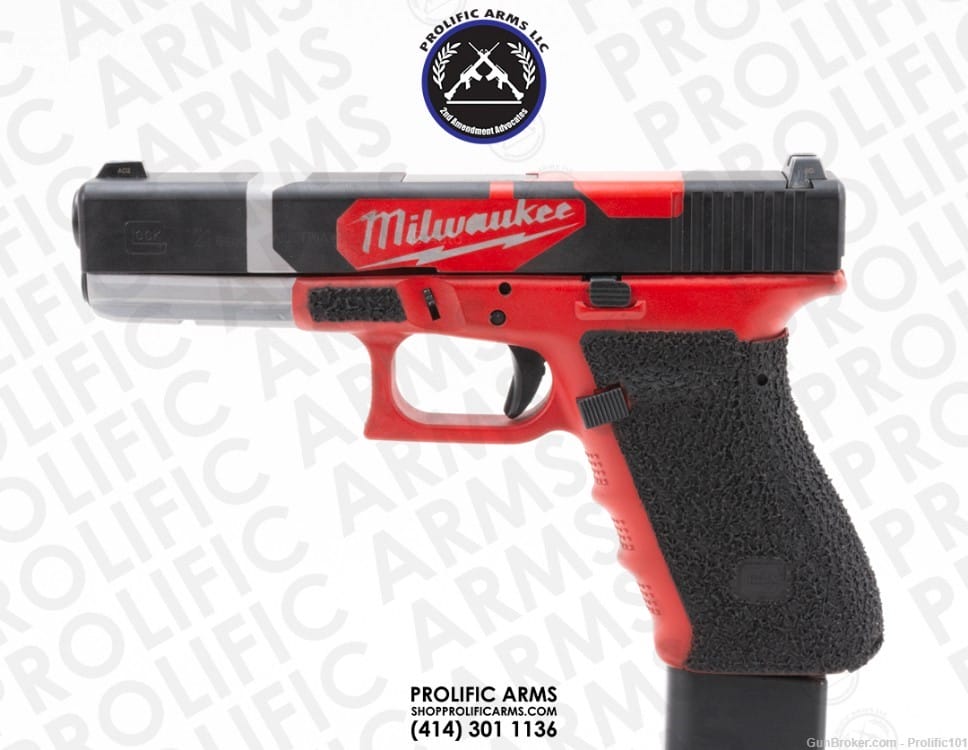 A handgun with a black and red design and "Milwaukee" written on the slide. The grip has a textured surface.